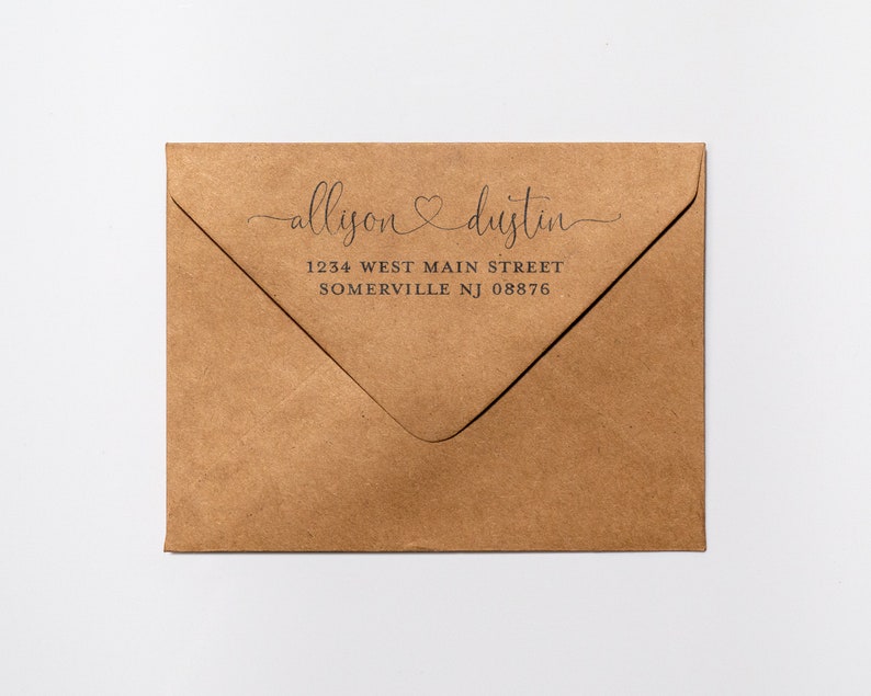 May include: A brown paper envelope with a return address label that reads "allison & dustin" with a heart symbol between the names. The address is 1234 West Main Street, Somerville NJ 08876.