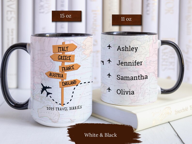 May include: Two white ceramic mugs with black handles. One mug features a map with a plane and a signpost with the words "Italy", "Greece", "France", "Austria", and "England". The other mug has a map with the names "Ashley", "Jennifer", "Samantha", and "Olivia". Both mugs have the text "2025 Travel Diaries".