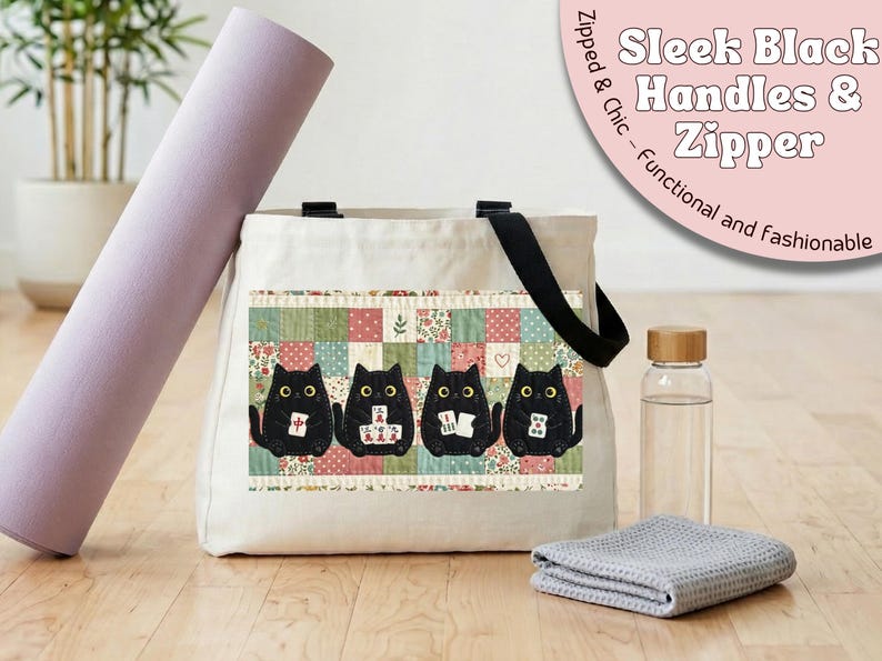 May include: A cream-colored canvas tote bag featuring black handles and a zipper closure. The front displays a graphic of four black cats playing mahjong against a background of colorful, small-scale floral and geometric quilt-style fabric patches.