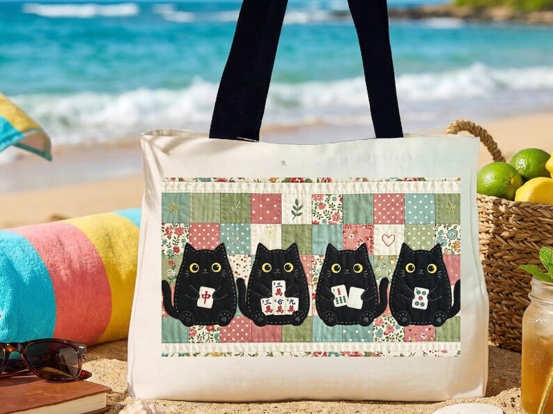 May include: A cream-colored canvas tote bag with black shoulder straps. The front features a printed patchwork design in shades of green, pink, and white, displaying four black cats holding mahjong tiles with various Chinese characters.