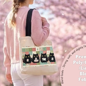 May include: A beige tote bag with black shoulder straps featuring a graphic of four black cats holding mahjong tiles against a patchwork background. The text on the bag reads: Blend Goals - Strong, soft, and slightly fancy Premium Poly/Cotton/Linen Blend Fabric.