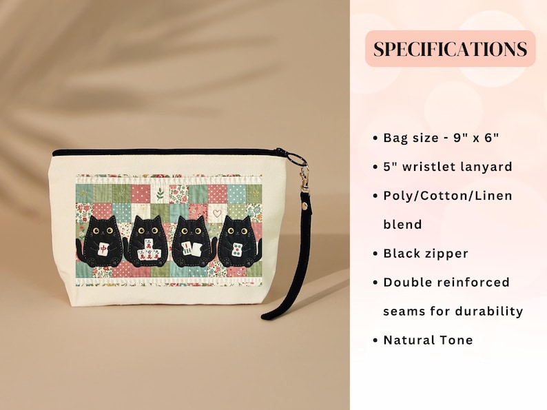 May include: A natural-toned pouch with a black zipper and a 5-inch wristlet lanyard. The front features a graphic of four black cats playing mahjong against a colorful patchwork background. The bag measures 9 inches by 6 inches and is made of a poly, cotton, and linen blend.