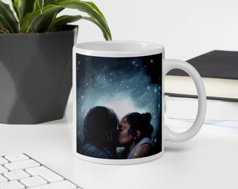 May include: White ceramic mug with a dark blue and black illustration of two people kissing in front of a starry night sky.