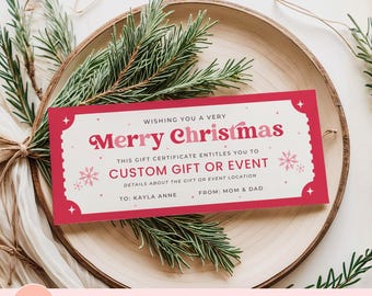 May include: A red and white Christmas gift certificate template with the words "Merry Christmas" in a retro font. The certificate includes space for a custom gift or event, and is decorated with snowflakes and stars. The certificate is on a wooden plate with pine branches.