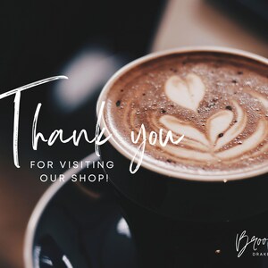 May include: A close-up of a cup of coffee with latte art. The text "Thank you for visiting our shop!" is written in white on a black background. The text "Brooke Drake Co." is written in white on a black background.