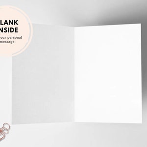 May include: A blank white card with a circle on the front that says "BLANK INSIDE for your personal message". The card is open and the inside is blank. Two gold binder clips are on the white surface.