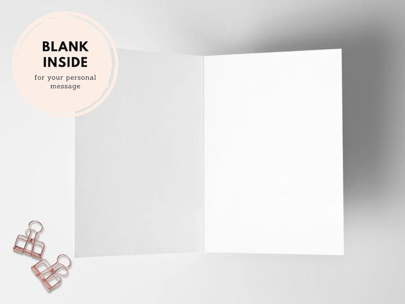 May include: A blank white card with a circle on the front that says "BLANK INSIDE for your personal message". The card is open and the inside is blank. Two gold binder clips are on the white surface.