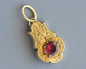 Antique Victorian period flat cut garnet hand engraved charm/pendant in 10k gold