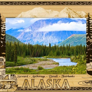 May include: A wooden picture frame with a scenic image of mountains, a river, and trees. The frame has a brown border with a carved design and the text "Seward - Anchorage - Denali - Fairbanks ALASKA" at the bottom.
