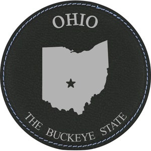 May include: Black leather coaster with a gray outline of the state of Ohio, a star in the center, and the text "OHIO THE BUCKEYE STATE".
