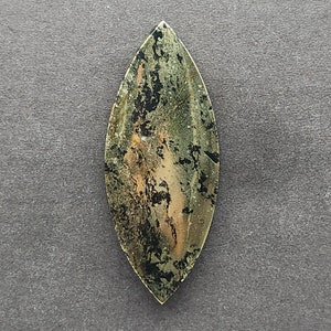 May include: A green, black, and gold leaf-shaped cabochon with a marbled pattern.
