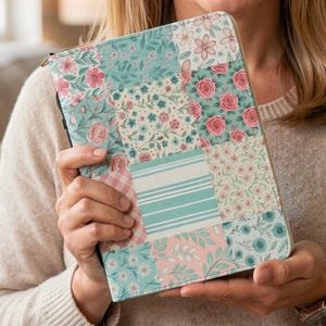 May include: A rectangular tablet case featuring a patchwork design with various floral, striped, and gingham patterns in shades of teal, light blue, pink, and white. The case has a structured, book-like appearance with a smooth, matte finish.