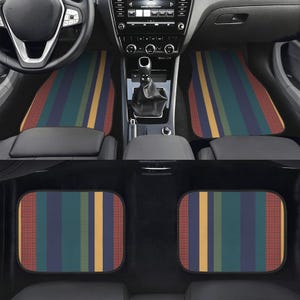 May include: A set of four car floor mats featuring a vertical striped pattern in shades of teal, navy blue, mustard yellow, and muted red. The mats have a textured surface and are shown installed in the front and rear footwells of a vehicle.