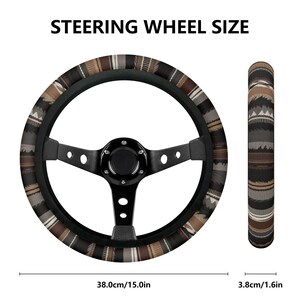 May include: Black steering wheel with a patterned cover in shades of brown, gray, and beige. The text "STEERING WHEEL SIZE" is at the top. The wheel measures 15.0 inches in diameter and 1.6 inches in width.