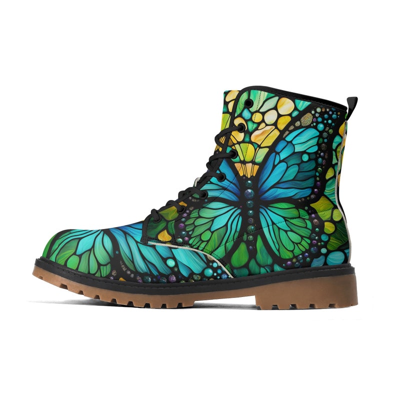 May include: Black leather boots with a colorful stained glass butterfly design. The butterfly has blue, green, and yellow wings.