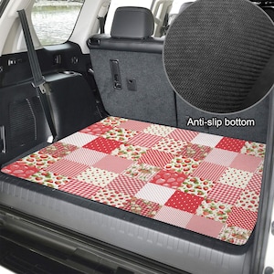 May include: A rectangular car trunk cargo mat featuring a patchwork design of red and white patterns, including strawberries, gingham checks, and polka dots. The mat has a black anti-slip bottom surface as shown in the circular inset detail.