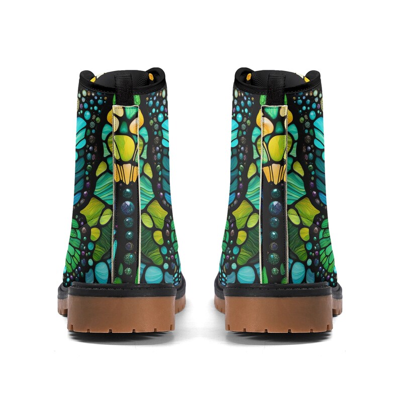 May include: A pair of black ankle boots with a green, blue, and yellow mosaic pattern. The boots have a brown sole and black laces.