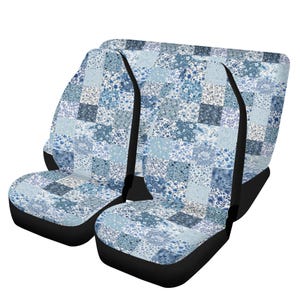 May include: Set of two car seat covers with a patchwork design in shades of blue and white. The covers feature a floral pattern and a black base. The seat covers are designed to fit most car seats.