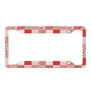 May include: A rectangular license plate frame featuring a patchwork design of red and white patterns. The design includes squares with red strawberries, red and white gingham checks, red and white stripes, and small red polka dots on white.