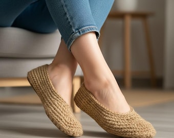 May include: Close-up of beige crochet slippers. The slippers have a rounded toe and a textured, woven appearance. The person wearing the slippers is also wearing blue jeans. The slippers appear to be handmade.