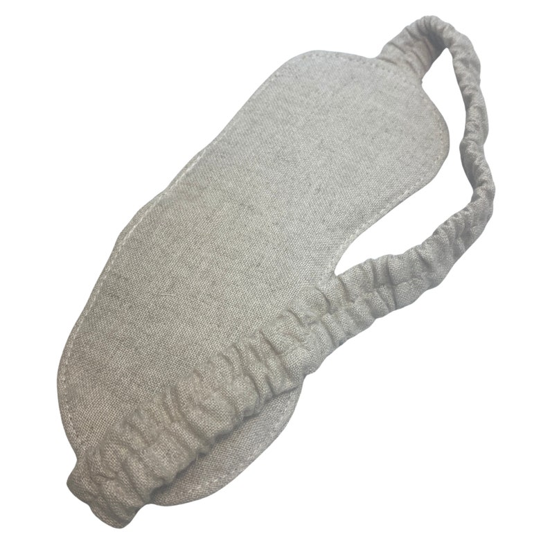 K&ouml;nnte beinhalten: Eine hellbeige Schlafmaske aus Leinen. Die Maske hat eine konturierte Form und ein passendes elastisches Band. Sie ist so konzipiert, dass sie das Licht blockiert und einen erholsamen Schlaf f&ouml;rdert. Das elastische Band sorgt f&uuml;r einen bequemen Sitz.