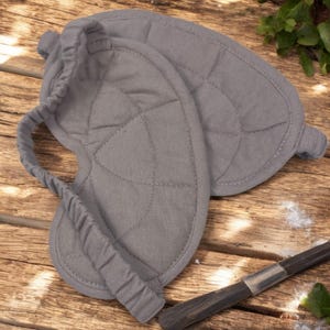 Puede incluir: M&aacute;scara para ojos acolchada gris con una banda el&aacute;stica. La m&aacute;scara est&aacute; hecha de tela suave y est&aacute; dise&ntilde;ada para bloquear la luz.