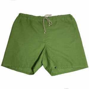 May include: Green linen shorts with a drawstring waist.
