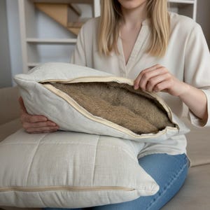 May include: A white ceramic mug with a black handle and the text "But First, Coffee" in a handwritten style. The mug is on a white surface. The mug is likely used for hot beverages.