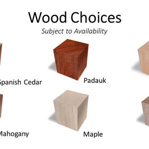 May include: Six wooden blocks, each a different wood type, are arranged in two rows of three. The wood types are Spanish Cedar, Mahogany, Maple, Padauk, Cherry, and Walnut. The text "Wood Choices" and "Subject to Availability" is above the blocks.