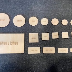 May include: Assortment of unfinished wood circles and squares in various sizes. The circles range from 1 inch to 60mm in diameter. The squares range from 1 inch to 40mm in width. A rectangular piece of wood measures 50mm x 120mm.
