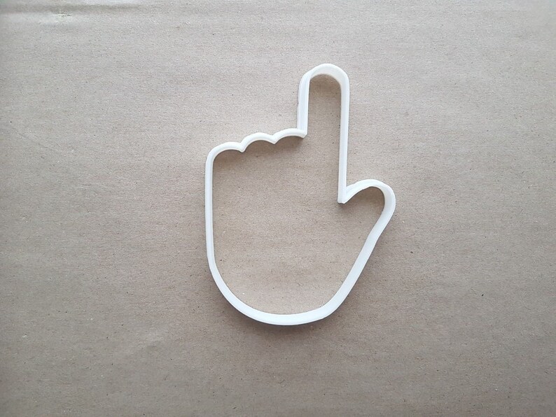 以下が含まれることがあります： 指を上に指した手の形をした白いプラスチック製のクッキーカッターです。