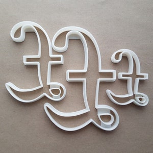 May include: White plastic cookie cutter in the shape of the letter "F" repeated three times.