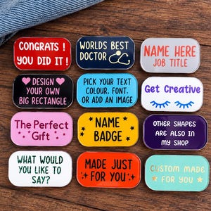 May include: A collection of twelve rectangular enamel pins in various colors, each featuring unique text and graphics including phrases like CONGRATS! YOU DID IT!, WORLDS BEST DOCTOR, NAME HERE JOB TITLE, DESIGN YOUR OWN, and CUSTOM MADE FOR YOU.