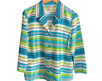 May include: A striped button-up shirt with a collar. The shirt is white, blue, green, and black. The shirt is hanging on a wooden hanger.