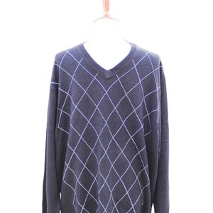 May include: A dark blue v-neck sweater with a white diamond pattern.