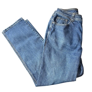 May include: A pair of light blue denim jeans. The jeans feature a classic five-pocket design, a button and zip closure, and a straight leg cut. The denim has a medium wash and visible stitching.