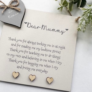 May include: A wooden sign with the text "Dear Mummy" and a sweet message of thanks for a mother's love. The sign is decorated with small wooden hearts.