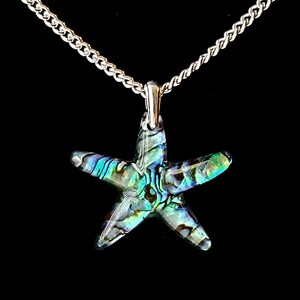 May include: A silver chain necklace with a iridescent abalone shell starfish pendant.