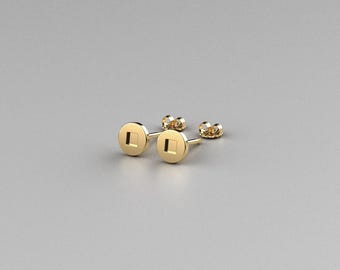 May include: A pair of gold stud earrings with a square design in the center of each round earring.