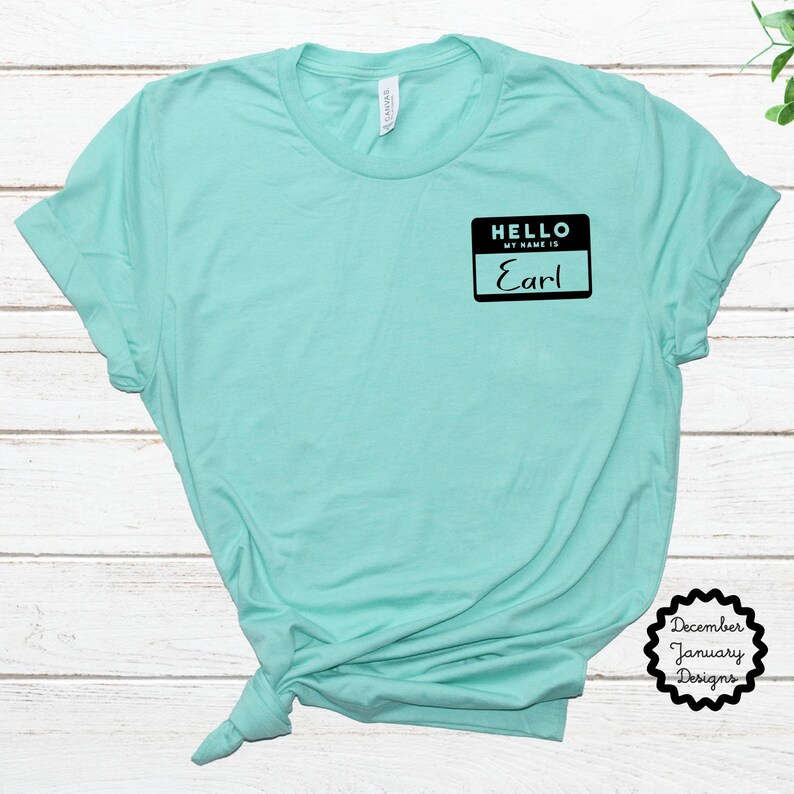 May include: A turquoise t-shirt with a black name tag that says "Hello, my name is Earl".