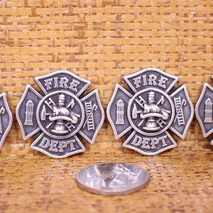 May include: Four silver-toned metal firefighter badges with the words "FIRE DEPT" and a fire hydrant, axe, ladder, and helmet design.