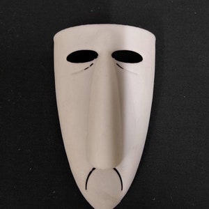 May include: White mask with a long, thin nose and black eyes. The mask has a slight frown.