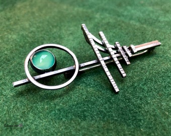 Silver brooch with green jade