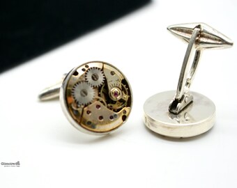 Silver cufflinks with golden clock mechanisms -movable clip art.378