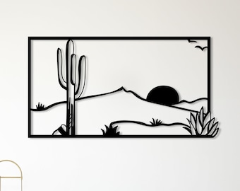 Può includere: Arte da parete in metallo nero che rappresenta un paesaggio desertico con un cactus, montagne e un tramonto.