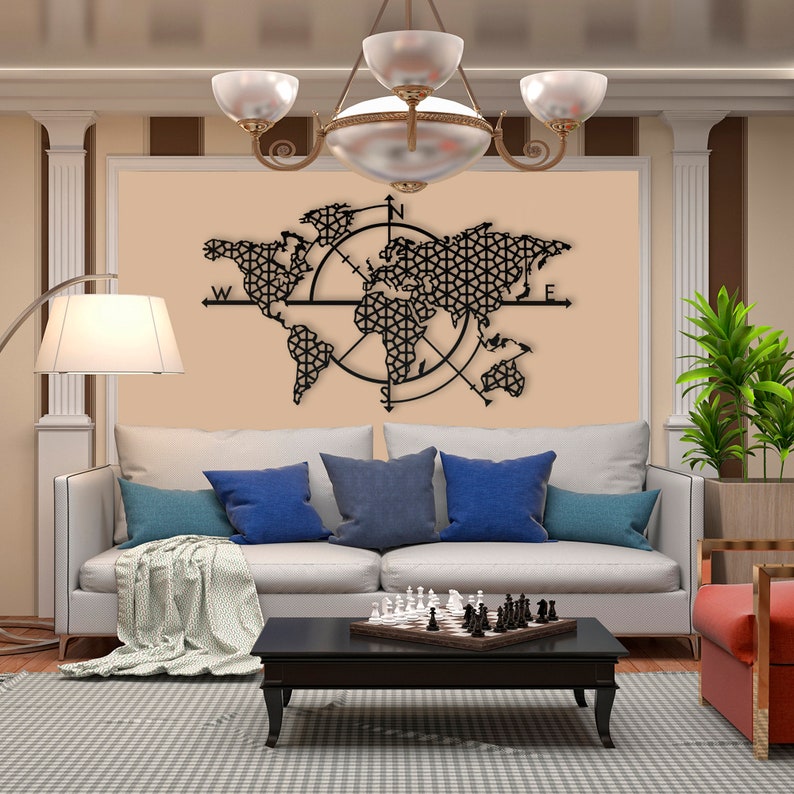 May include: Black metal wall art featuring a world map with a compass design. The map is detailed with geometric patterns and includes the cardinal directions: North, South, East, and West.