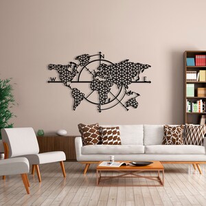 May include: Black metal wall art featuring a world map with a compass design. The map is surrounded by a circle with compass points N, S, E, and W. The map is detailed and intricate, with a geometric pattern.