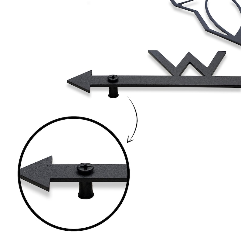 May include: Close-up of a black metal arrow with a screw and a black metal cap. The arrow is attached to a metal rod. The arrow is pointing to the left.