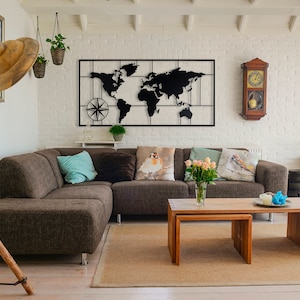 May include: A brown sectional sofa with pillows in a living room with a black metal world map wall decor, a wooden clock, and a wooden coffee table.