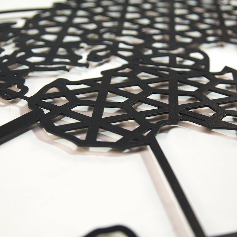 May include: A black metal world map wall decor with a geometric design. The map is cut out in a grid pattern, creating a modern and abstract look.